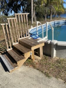Wood steps built for a semi-inground above ground pool